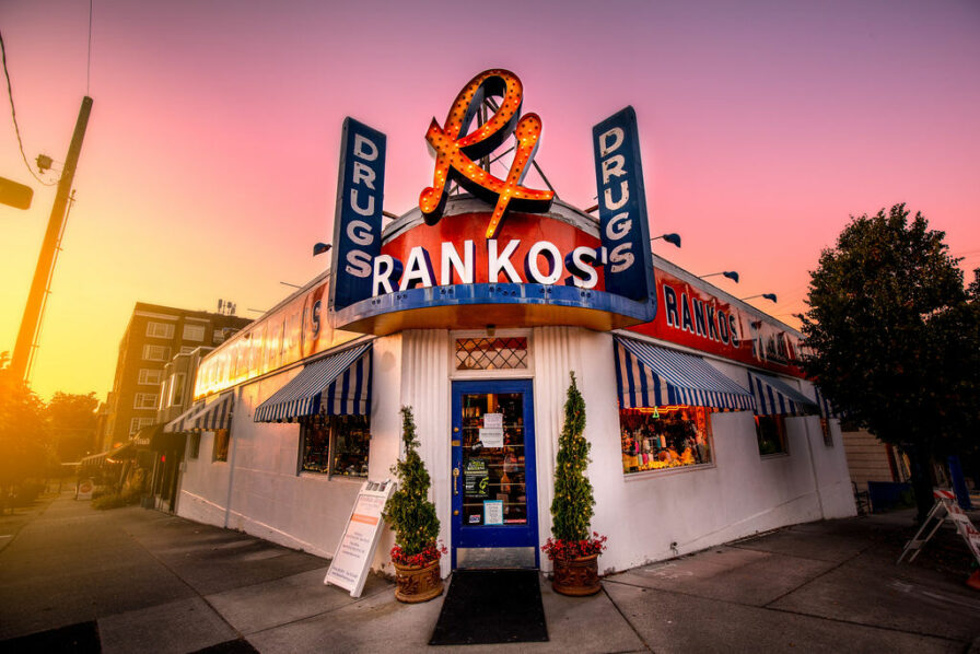 a photo of rankos pharmacy at sunset with its neon rankos sign featuring prominently
