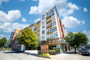 a photo of the apartments for rent at theas landing in tacoma with green trees and blue sky