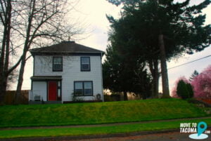 Beige house with red door in Central Tacoma, WA.