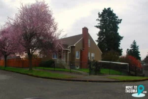 Beige house with red door in Central Tacoma, WA.
