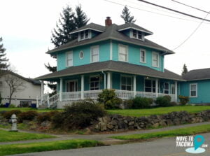 Teal house with wraparound porch in Tacoma's eastside neighborhood