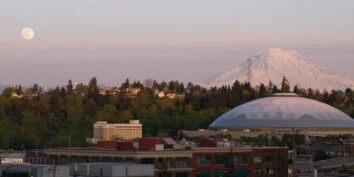 mt rainier over the tacoma dome under a full moon