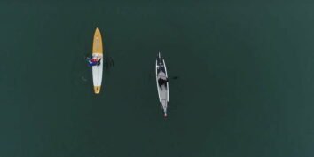 marguerite martin and dean burke paddle boarding in winter a