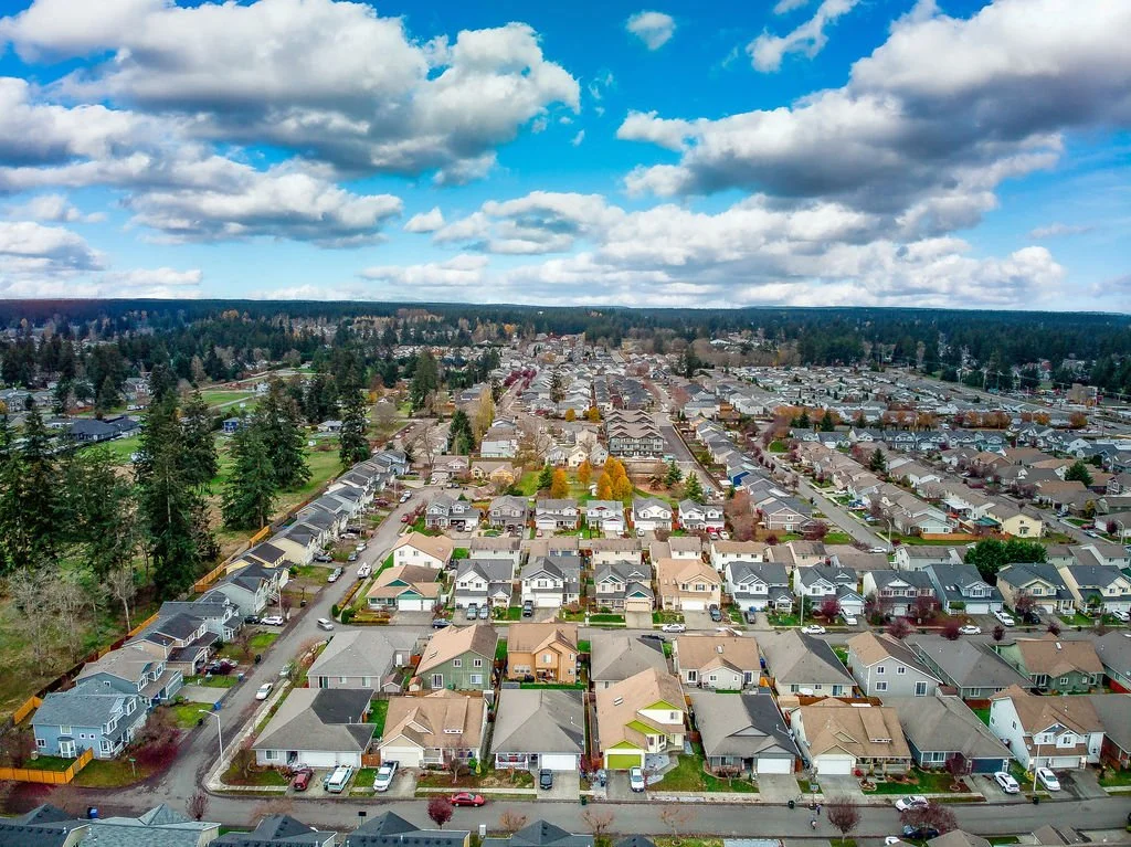 A housing development in Frederickson Washington photographed from above on a cloudy day. Frederickson is a neighborhood near JBLM and Tacoma, Washington.