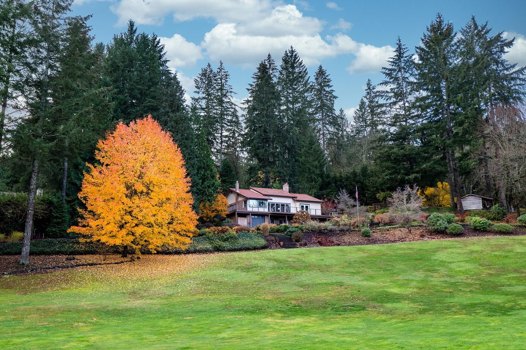 a home on land with trees around in the artondale neighborhood of gig harbor