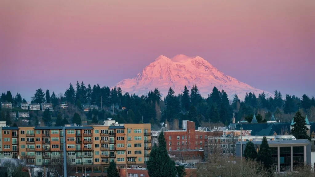 A photo of Olympia, Washington at sunset with Mt Rainier in the background. Olympia is a city near JBLM.