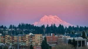 A photo of Olympia, Washington at sunset with Mt Rainier in the background. Olympia is an affordable city near JBLM.