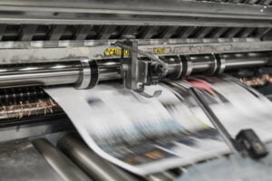 an image of a newspaper being printed in a machine