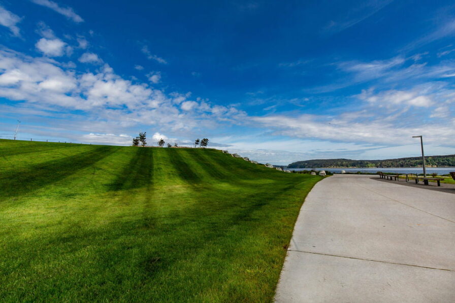 a walking path with green grass in the point ruston neighborhood of tacoma washington