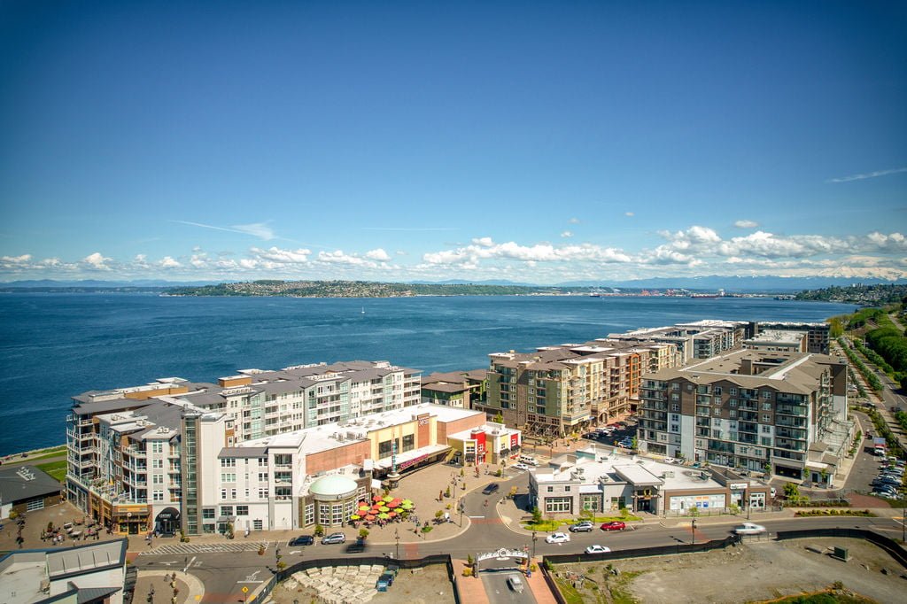 condos, apartments, a movie theater, and restaurants in the point ruston neighborhood of tacoma with commencement bay in the background