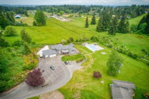 a home on a hill with a swimming pool surrounded by acreage and trees in the waller neighborhood of tacoma