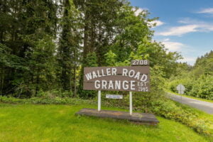 a wooden sign that says "waller road grange" in Tacoma WA