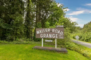 a wooden sign that says "waller road grange" in Tacoma WA