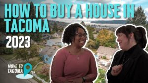 The words "how to buy a house in Tacoma 2023" with two realtors speaking to each other