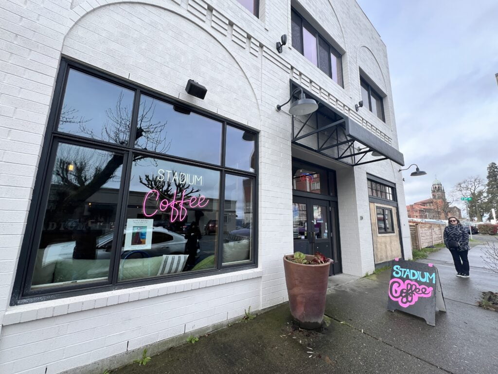 the exterior of local tacoma coffee shop Stadium Cafe in the Stadium District Neighborhood of Tacoma, Washington. The exteior is white brick 