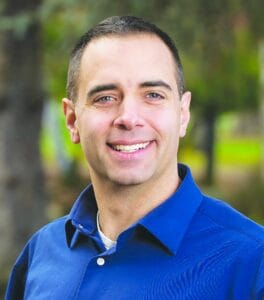Tacoma mayor Anders ibsen smiles at the camera wearing a blue collar shirt