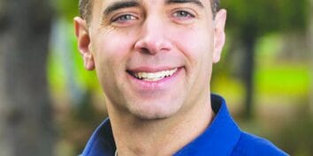 Tacoma mayor Anders ibsen smiles at the camera wearing a blue collar shirt