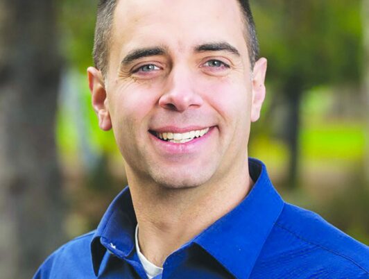 Tacoma mayor Anders ibsen smiles at the camera wearing a blue collar shirt