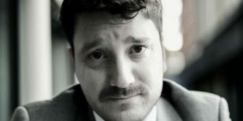 nicholas carr in black and white wearing a suit and tie