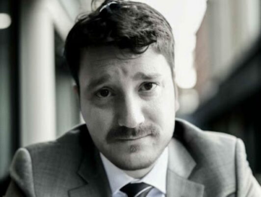 nicholas carr in black and white wearing a suit and tie