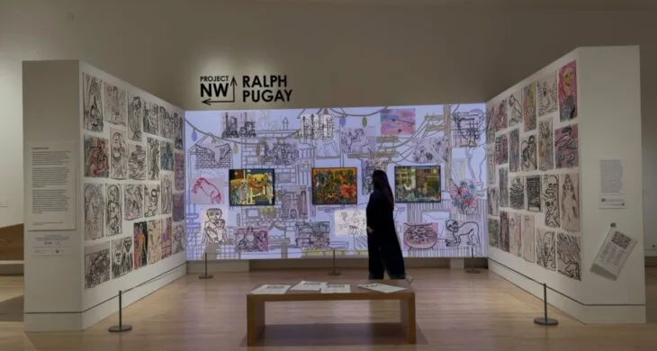 Marguerite Martin walks through the Ralph Pugay exhibit at Tacoma Art Museum in 2026.