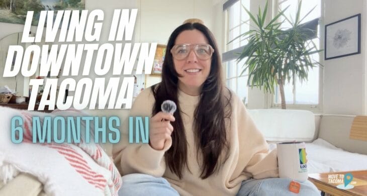 Tacoma real estate agent Marguerite Martin sits on a sofa with legs crossed with the words "Living in Downtown Tacoma: 6 months in"
