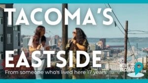 A photo of two people on Mckinley Hill on tacoma's eastside, both with long hair speaking to each other about the neighborhood.